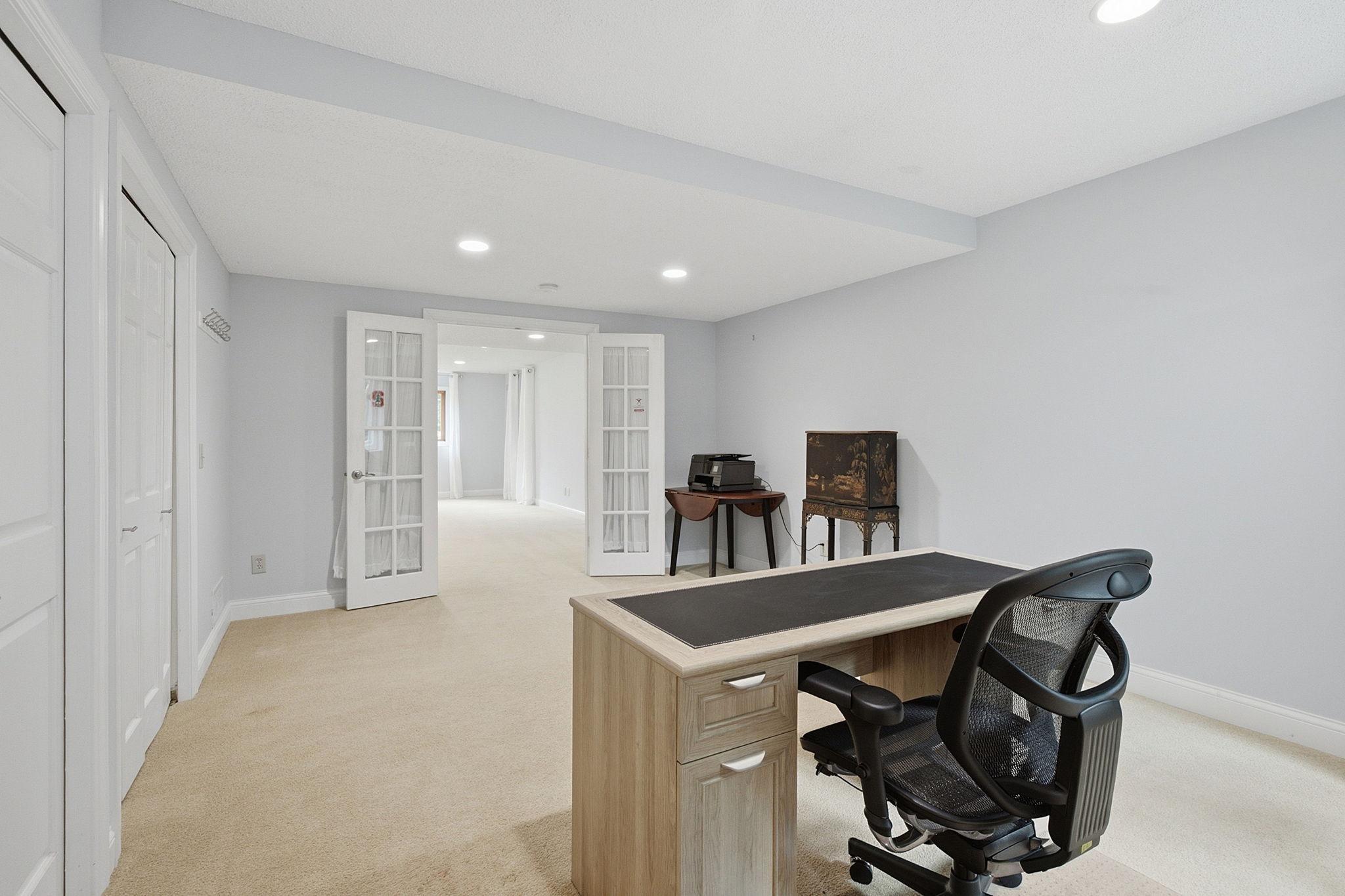 Spacious lower-level bedroom offers flexibility for guests, work, or hobbies or 2nd home office.