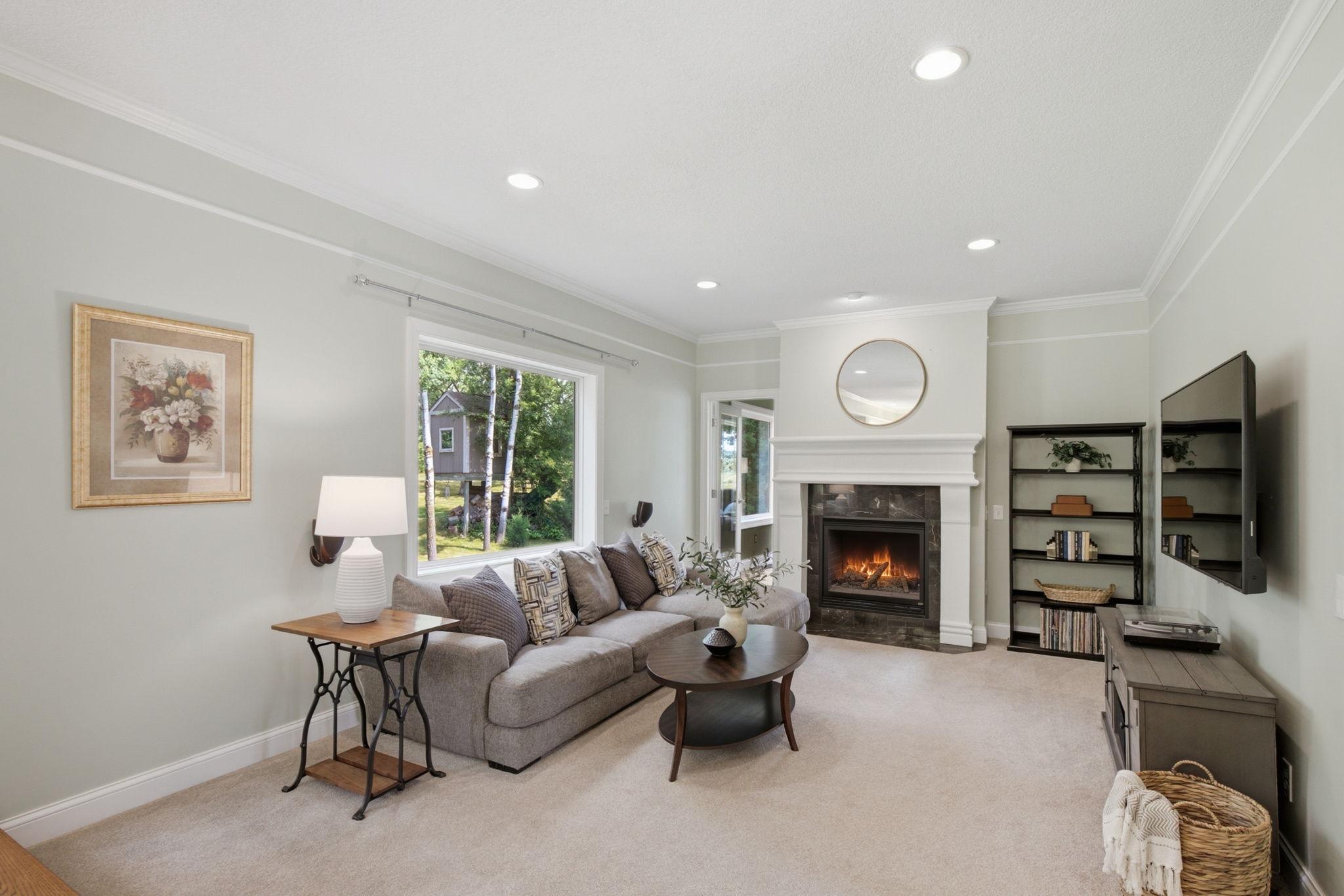 Open-concept family room centered around a stunning two-sided gas fireplace.