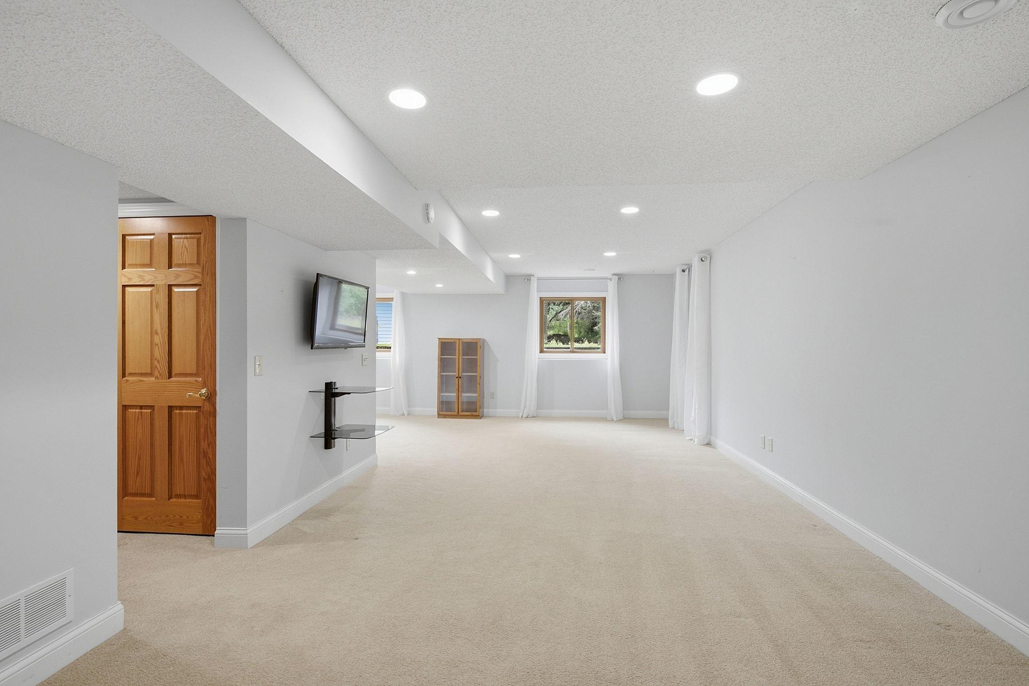 Thoughtfully finished lower level includes a family room, guest suite, and ¾ bath.