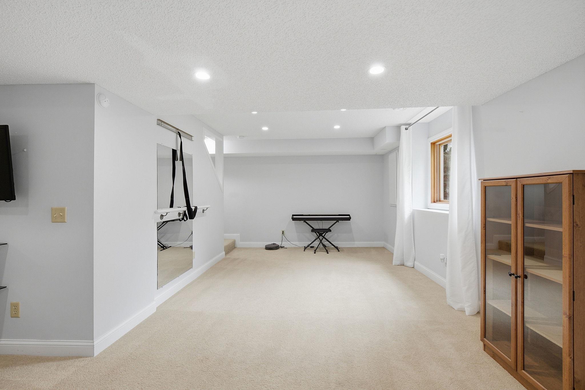 Finished lower level provides flexible space for a game room, home gym, or media area.