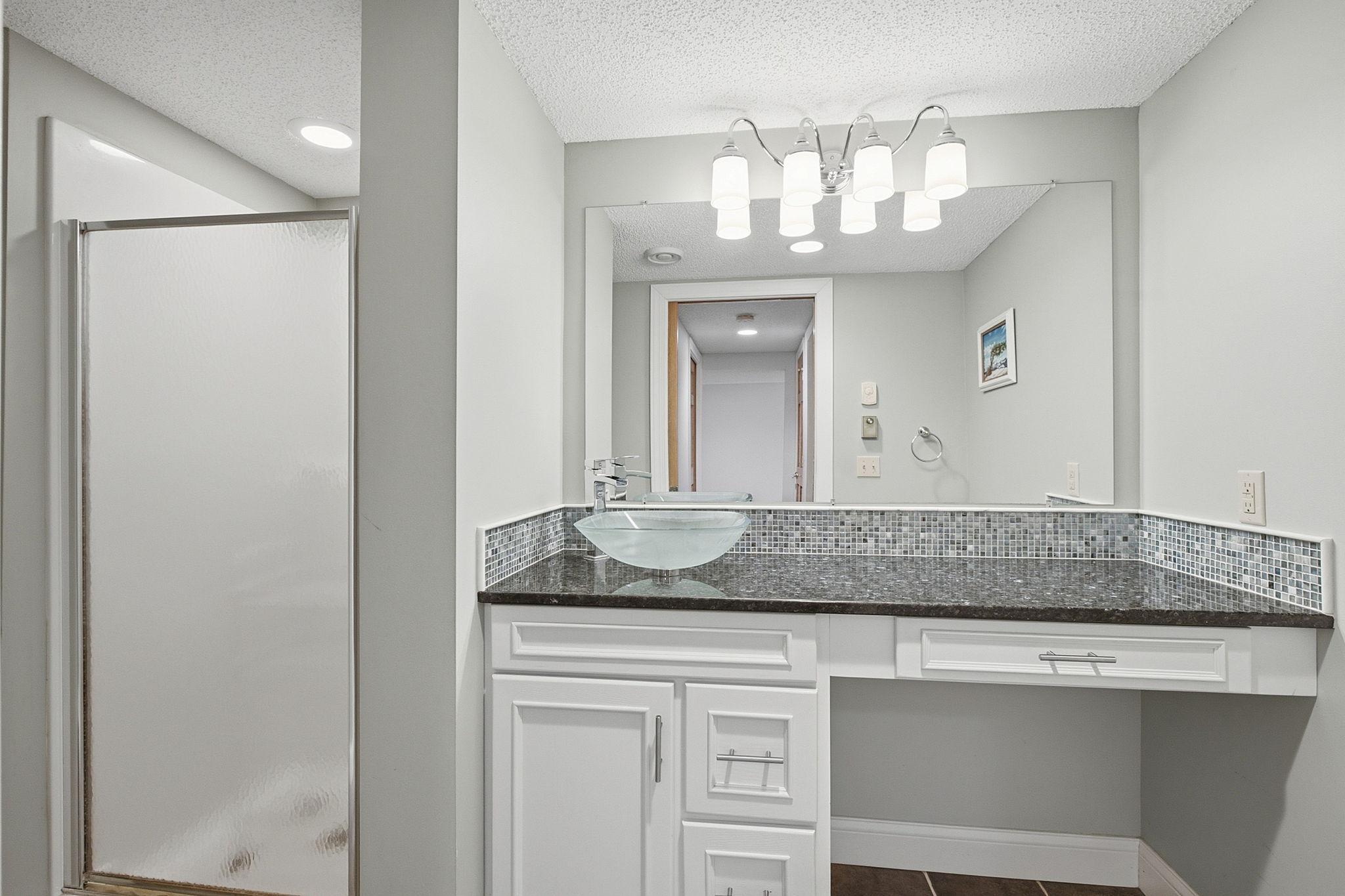 Lower-level ¾ bath with heated floors adds comfort for guests.