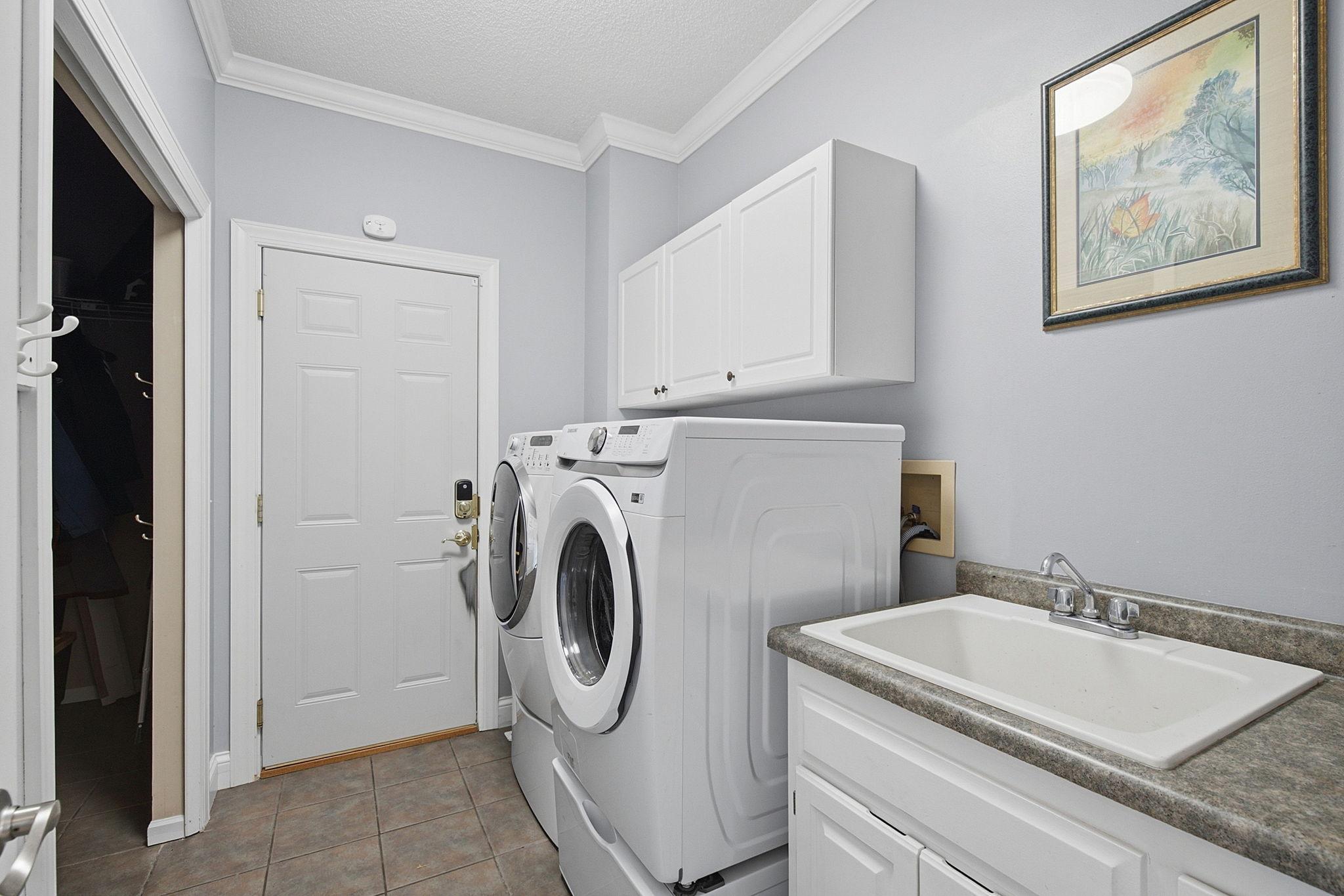 Main floor laundry with wash tub and large mud closet