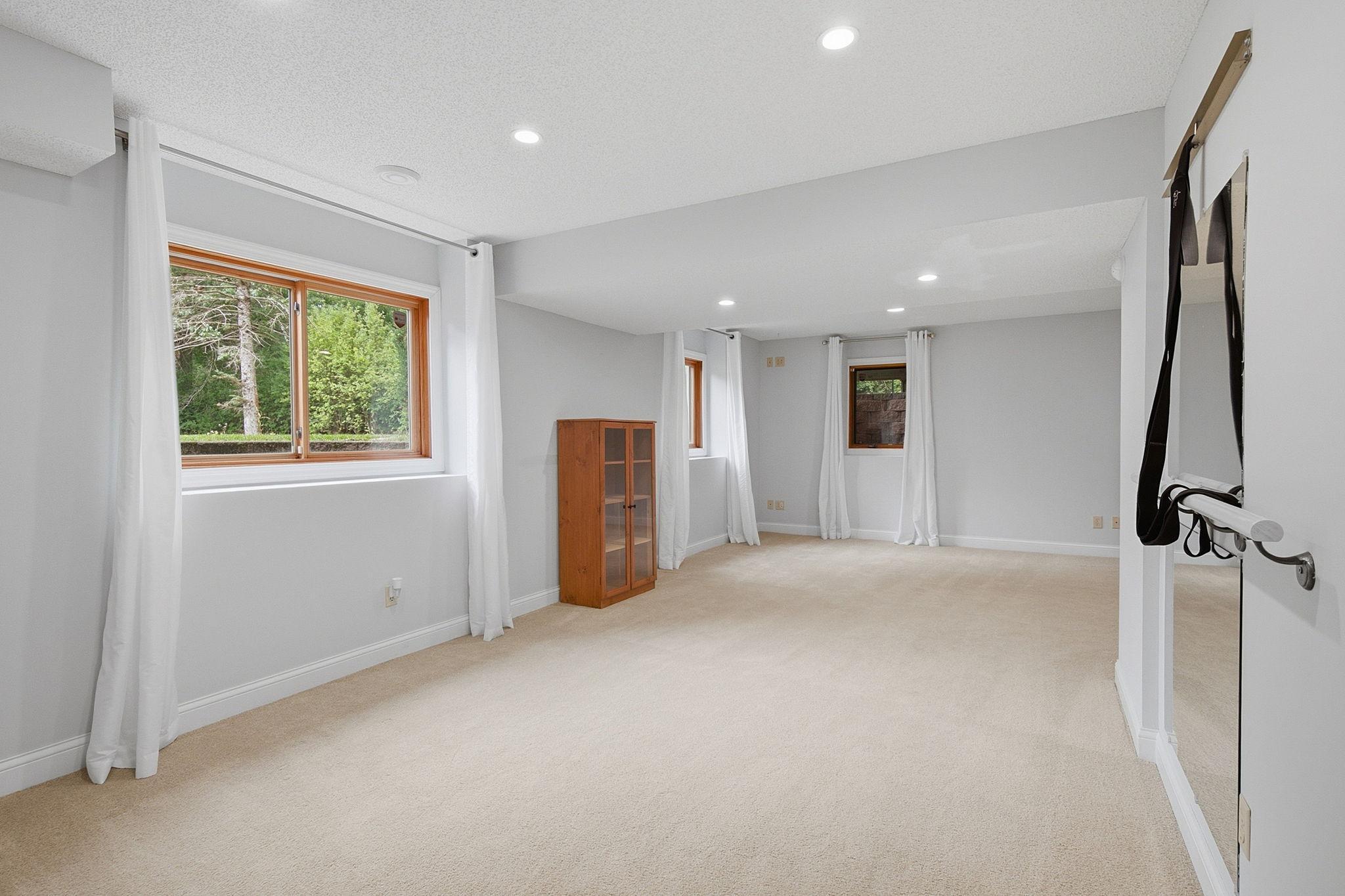 Expansive lower-level family room offers endless possibilities for entertaining.