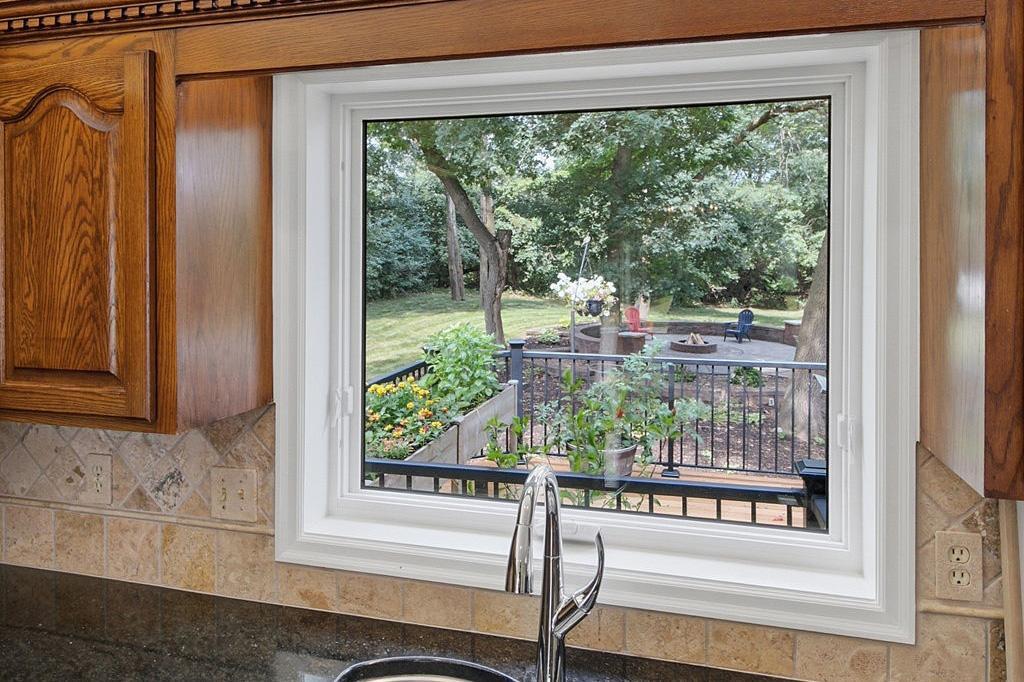 Large kitchen window fills the space with natural light while overlooking the backyard.