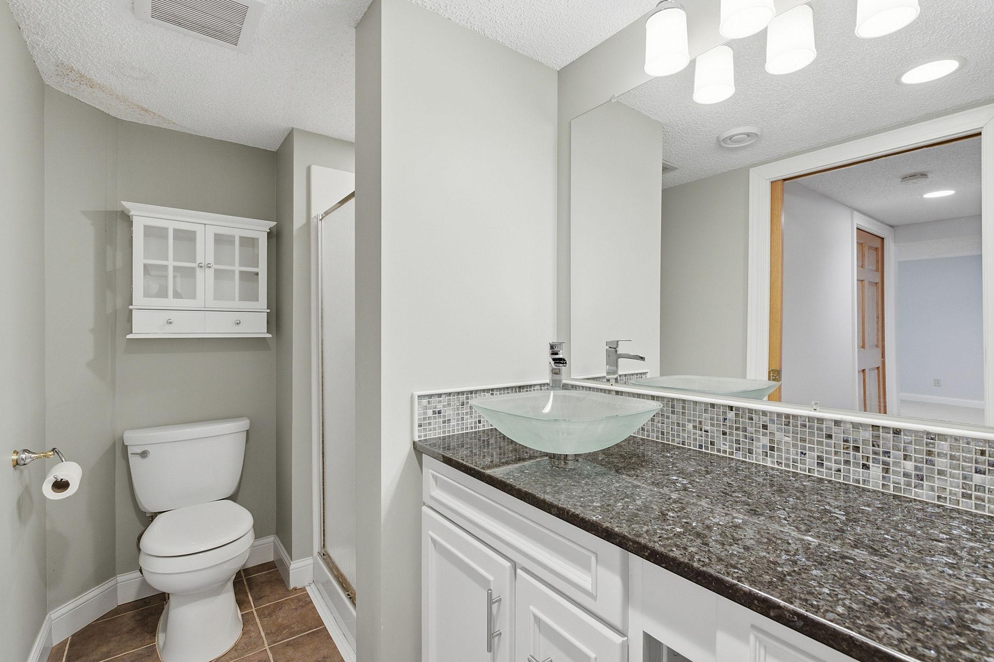 Convenient lower-level bathroom featuring the luxury of heated floors.