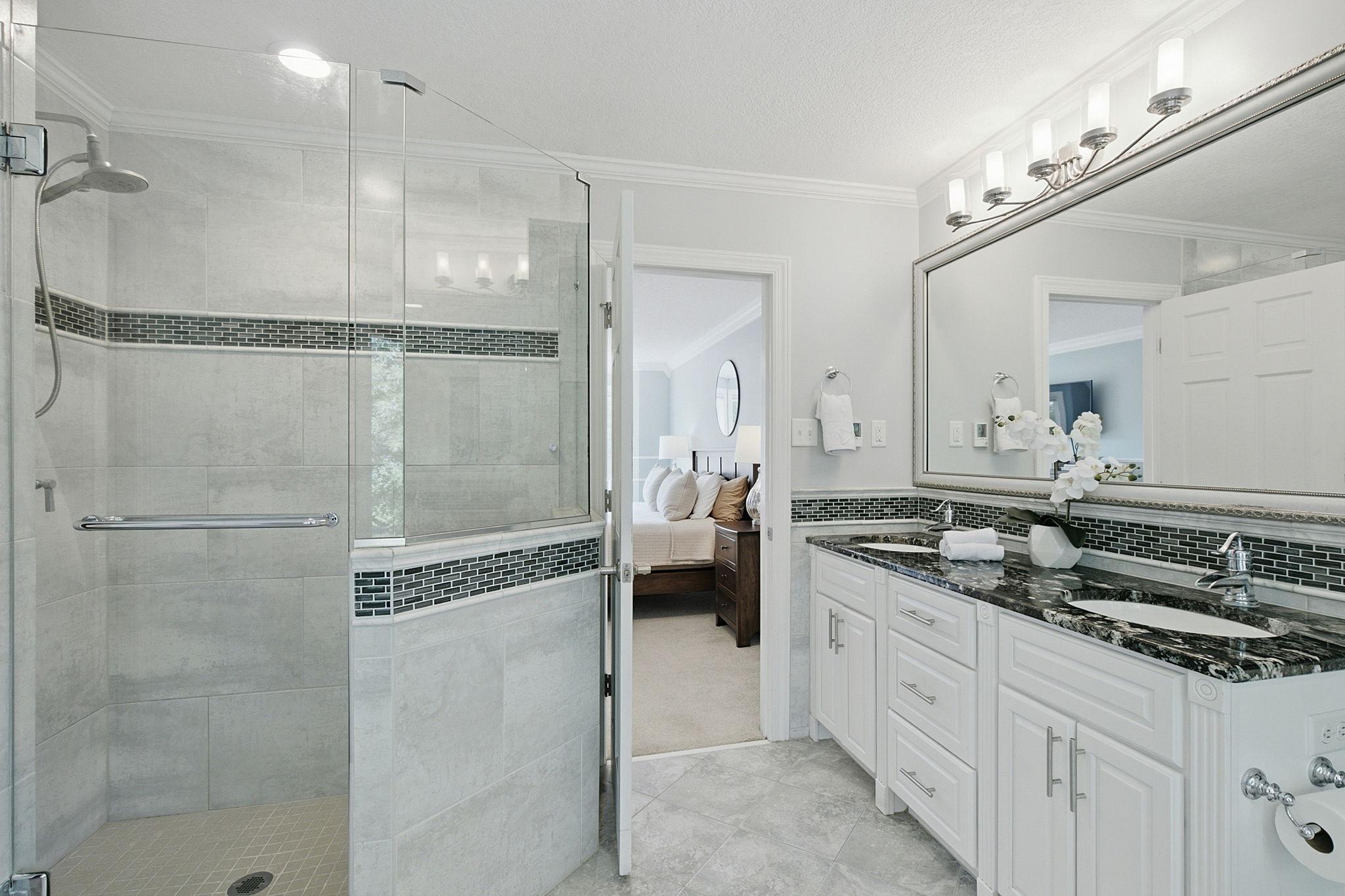 Beautifully remodeled ensuite featuring a walk-in shower and heated floors.