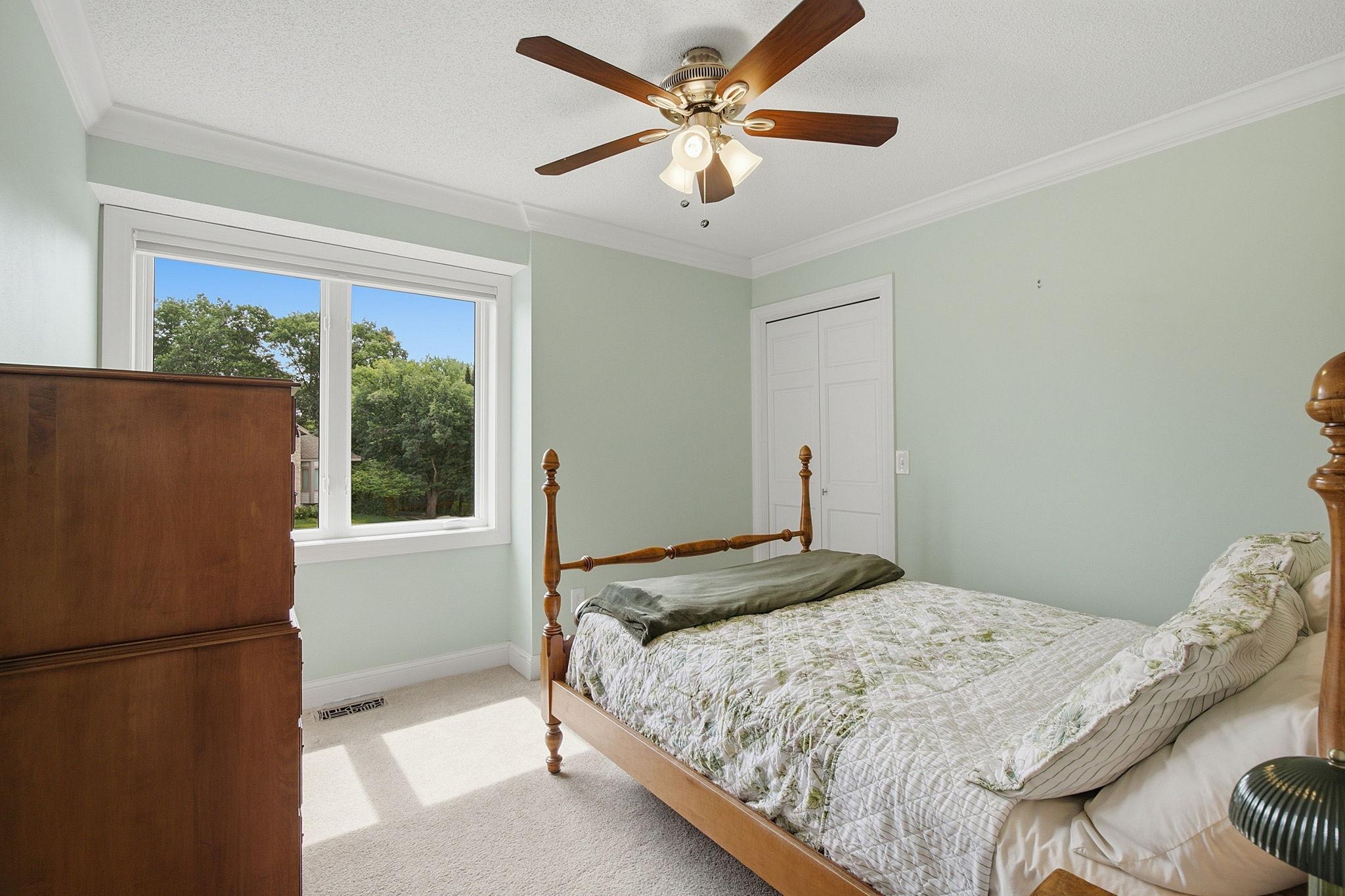 Bright upper-level bedroom with generous closet space.