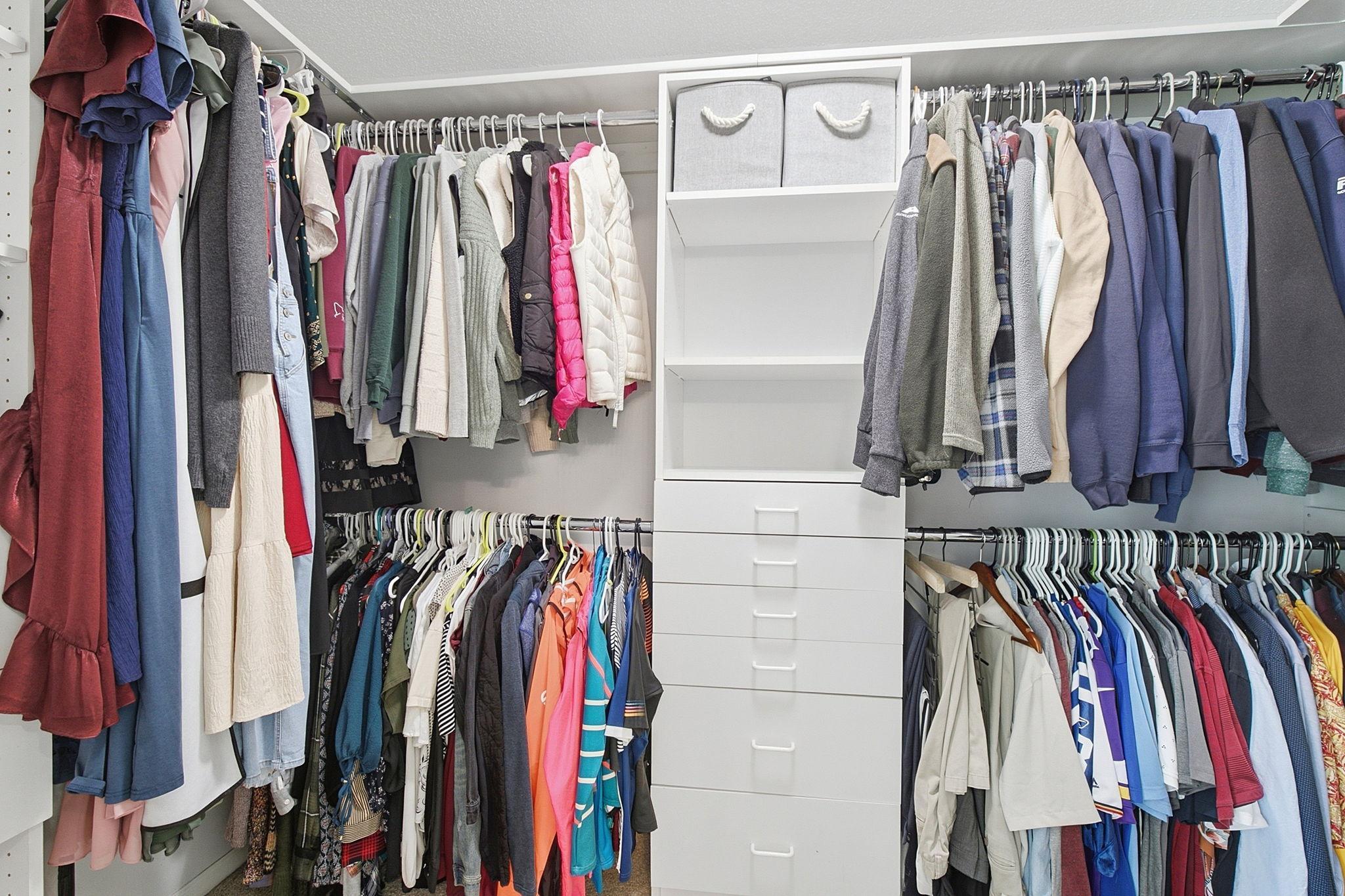 Expansive walk-in closet offers exceptional storage and organization.