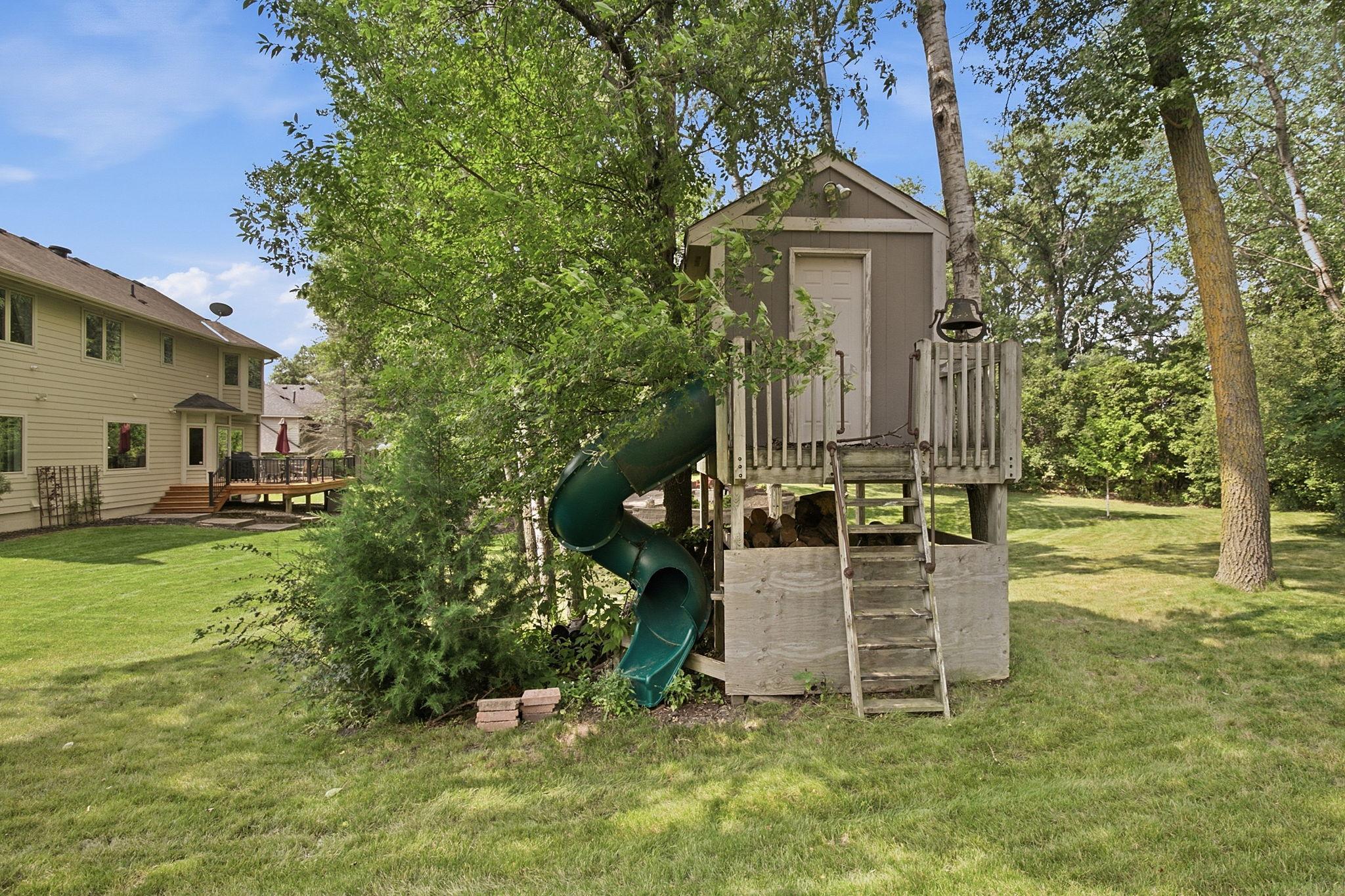 Backyard playhouse and slide provide endless fun for little ones.