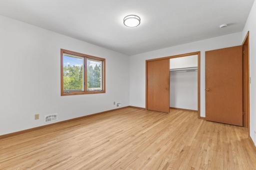 Newly refinished natural wood floors extend into both main level bedrooms plus professional paint and light fixtures.