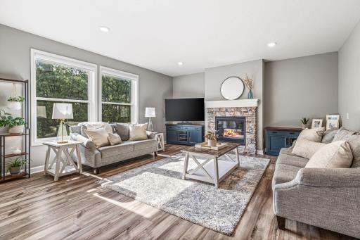 Cozy and inviting main floor living room featuring a gas fireplace with stylish stone accent.