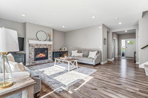 Another view of the living room showcasing the gleaming plank flooring.