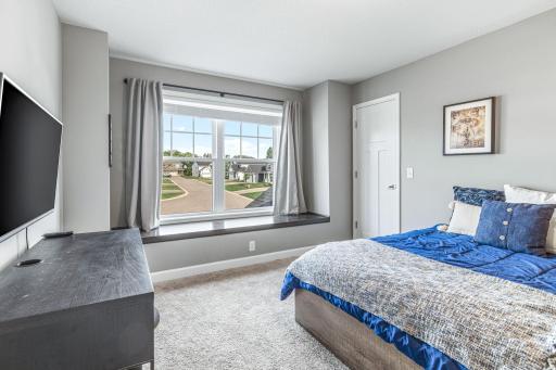 Window seat for relaxing with a good book and a walk-in closet.