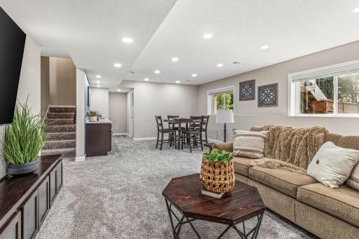 Open and bright lower level with lots of recessed lighting.