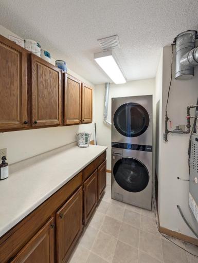 In-unit laundry with storage and counter space!