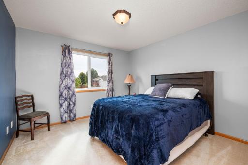 Additional well-lit bedroom featuring clean neutral decor