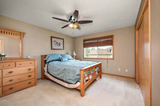 Comfortable primary bedroom with a ceiling fan, natural lighting, and plenty of space for full bedroom furnishings