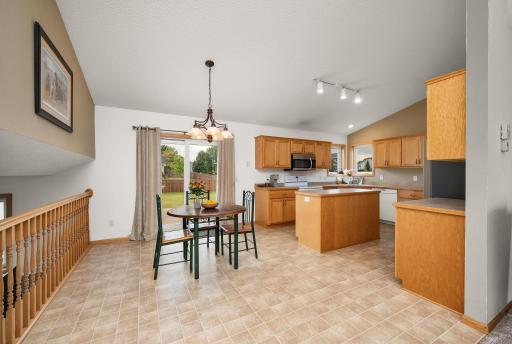 Seamless flow between the informal dining area and kitchen, featuring a center island