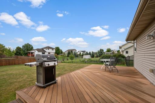 Outdoor entertainment deck overlooking the backyard, perfect for summer grilling and outdoor relaxation