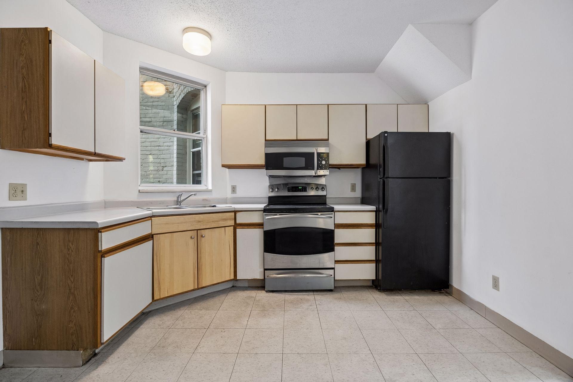 The open kitchen and informal dining area is conveniently located between the living room and the bedroom.