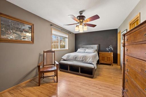 A spacious and inviting primary suite with warm tones, natural light, and plenty of room to unwind at the end of the day.