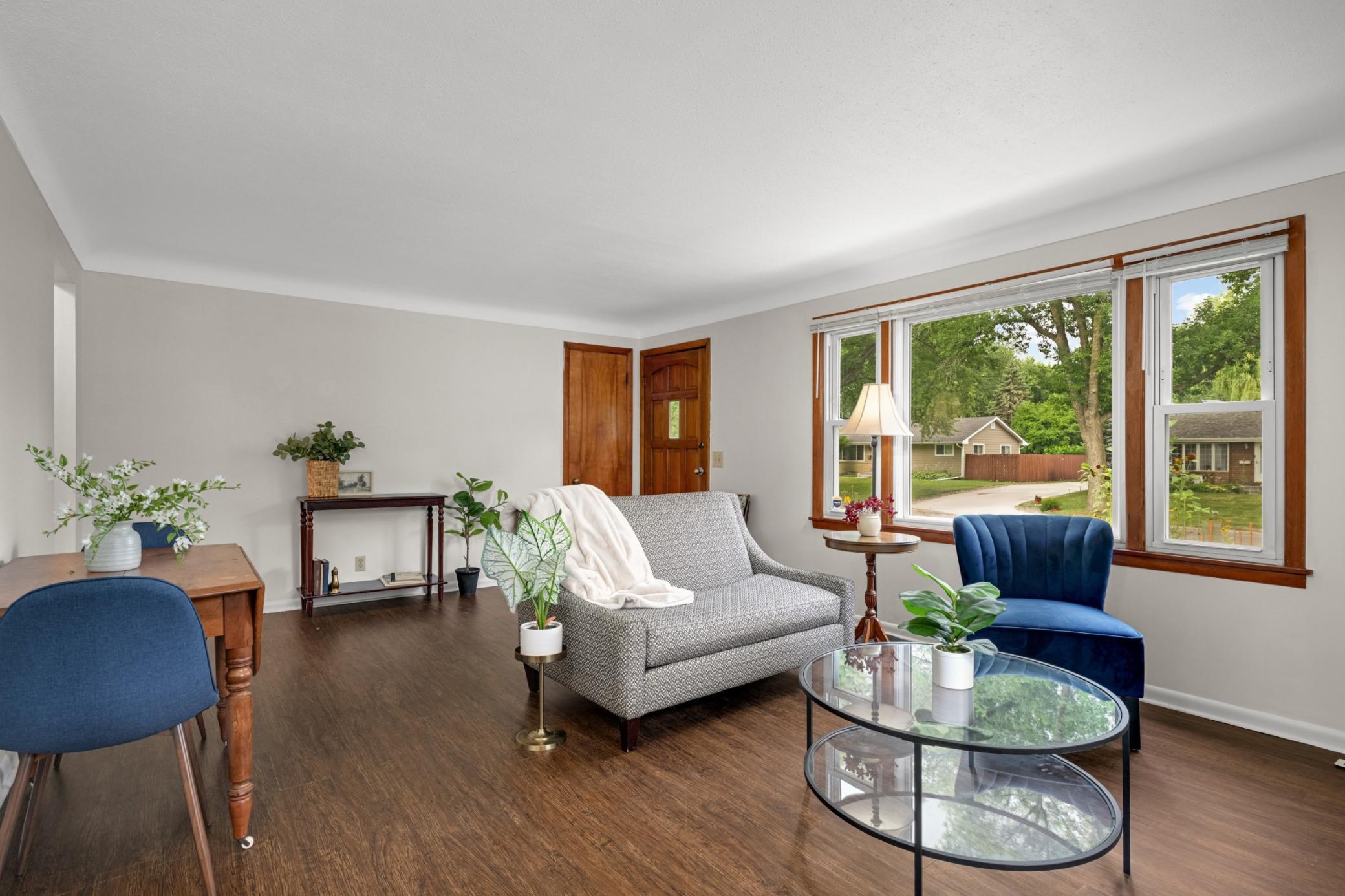 The living room is warm & open with a great view of the street.