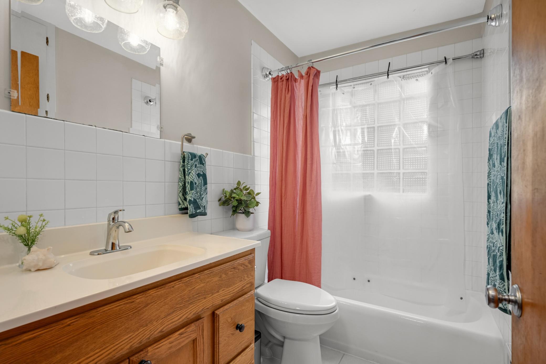 The full bath is spacious and bright.