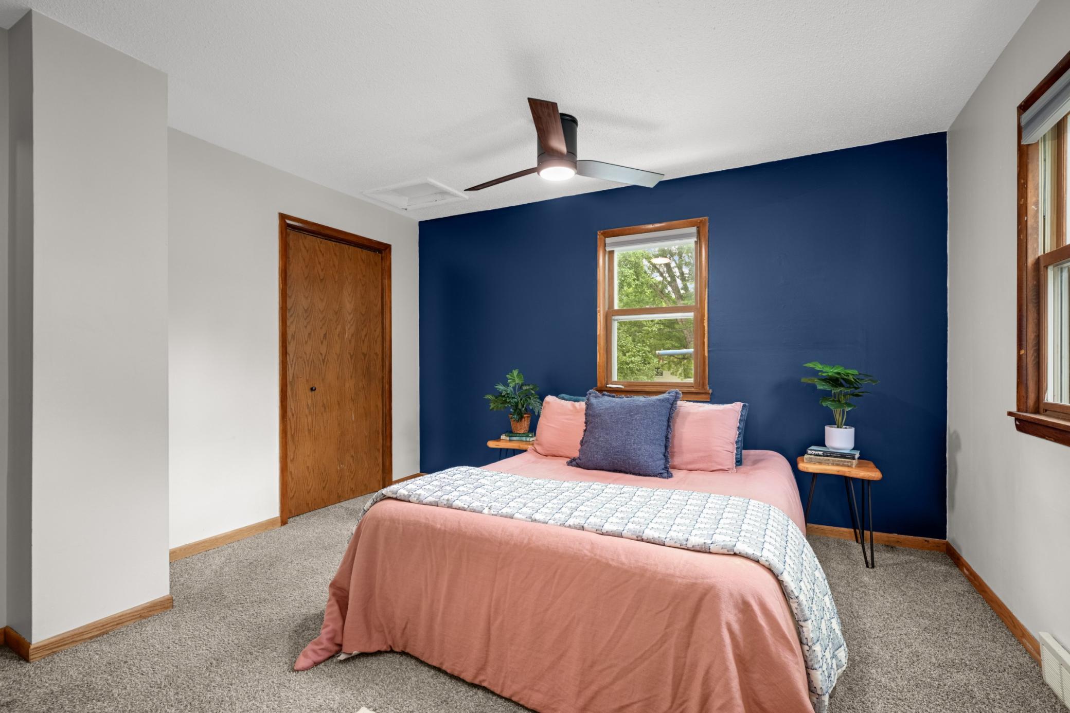 Bedroom 1 of 2 is located in the rear of the home.