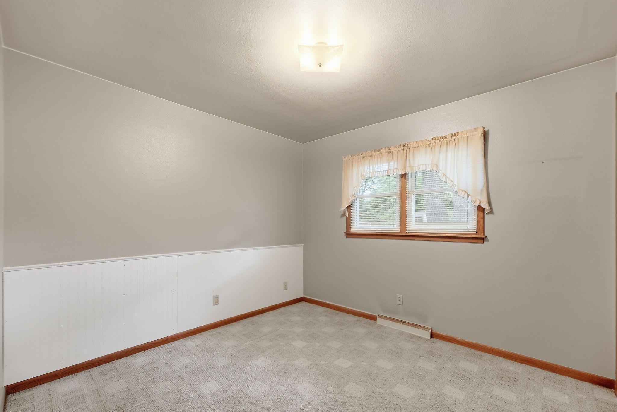 A bright, comfortable bedroom ready for your personal style.