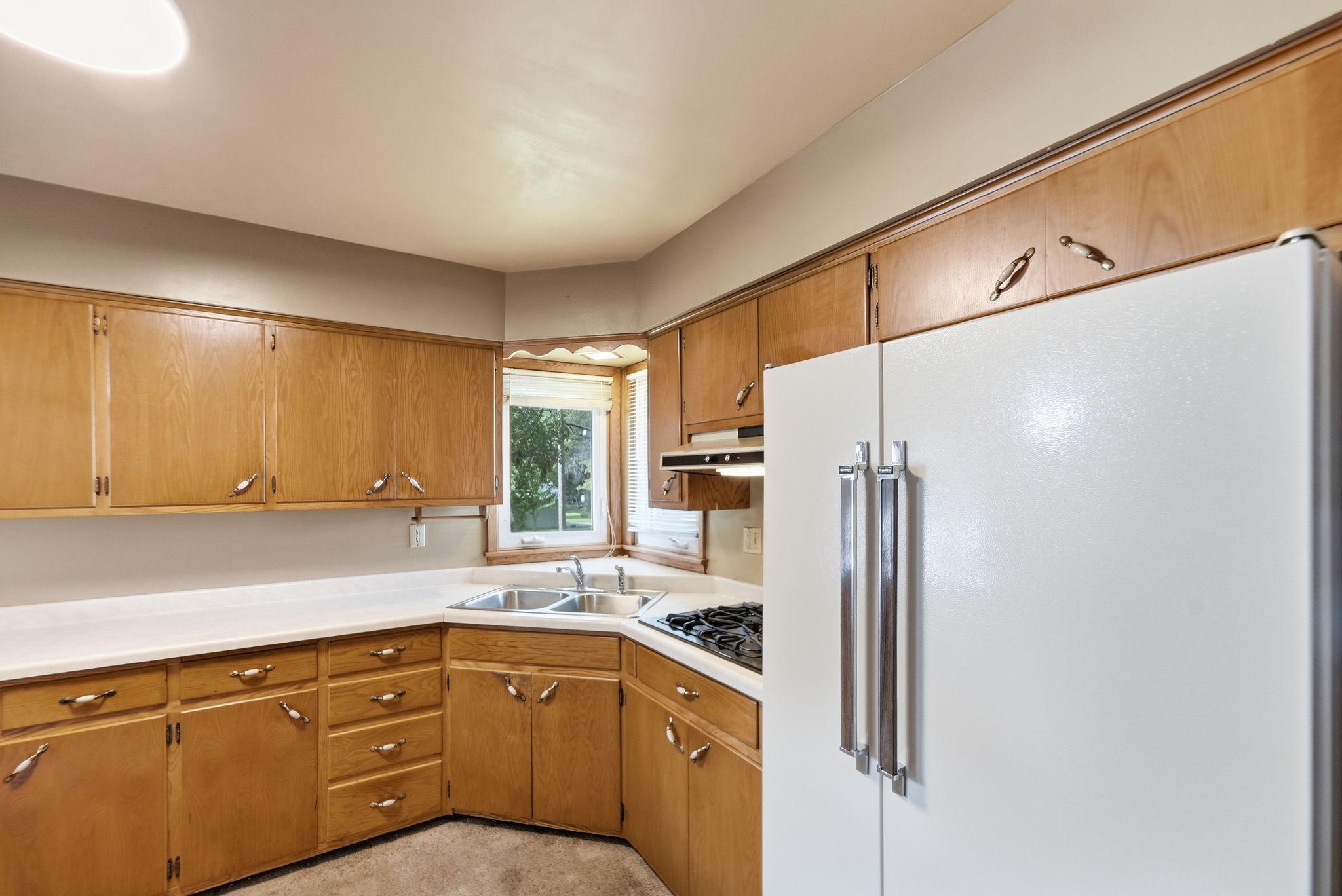 The kitchen window offers a pleasant outlook to the surrounding landscape.