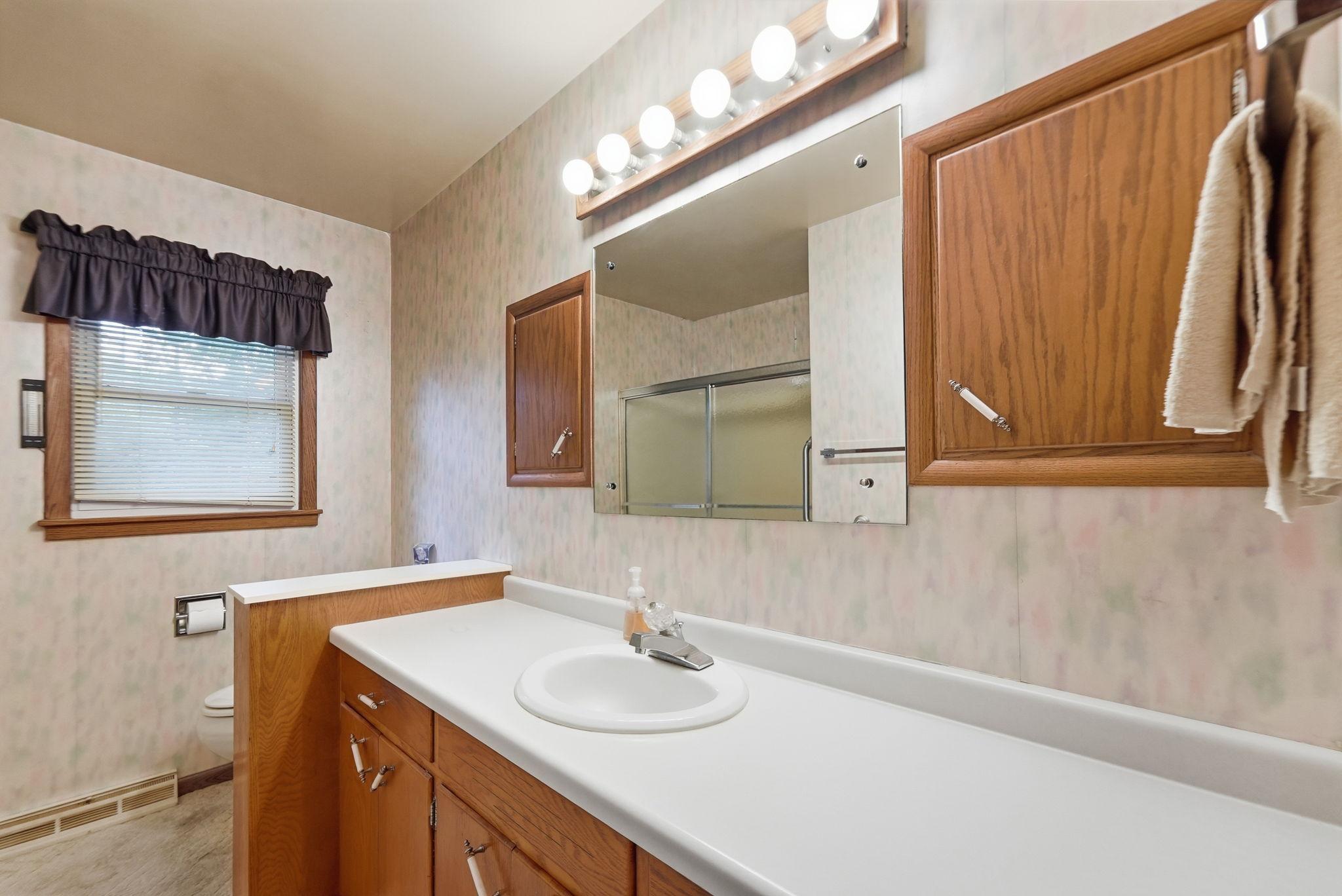 Full shared upper level bathroom with large vanity.