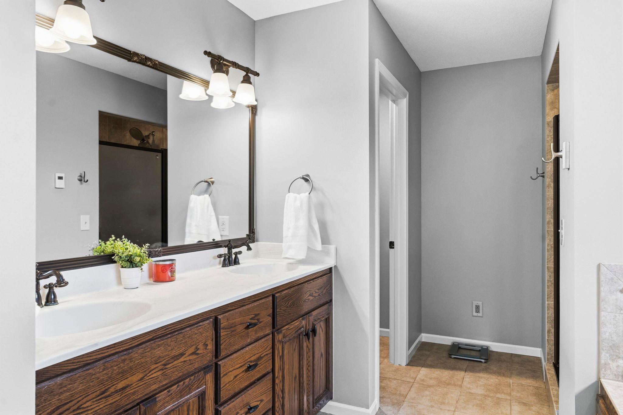 The owner's private bath has a double vanity sink, heated tile floors, a large walk-in shower with double shower heads.