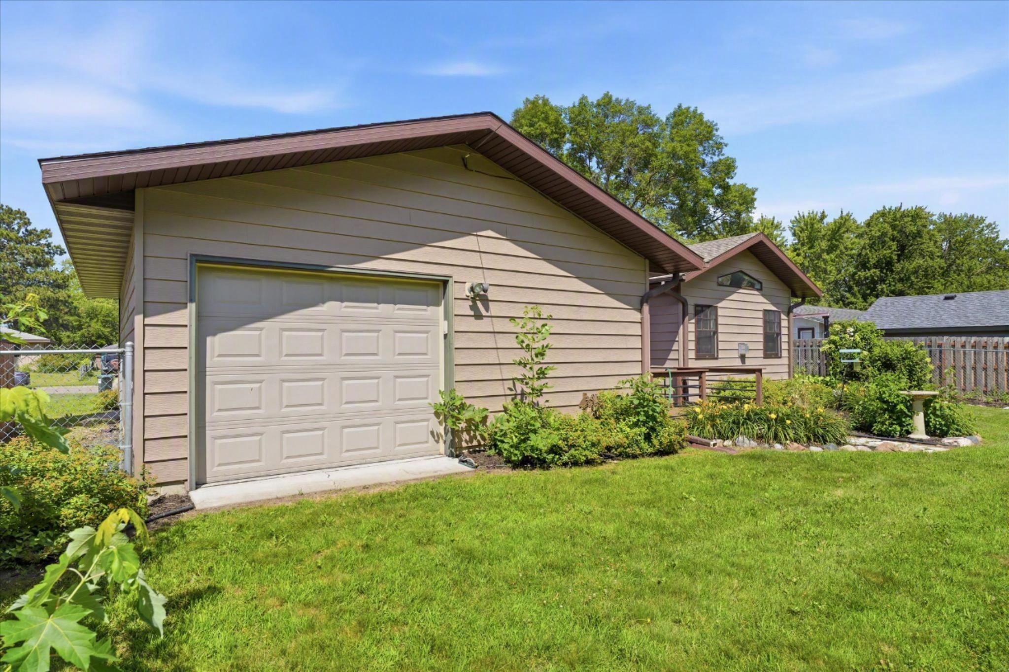 A rear service door and dedicated workshop area add exceptional convenience to this oversized garage!