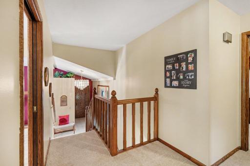 Owners put in this beautiful oak banister. This view shows the entry from both the garage and front door.