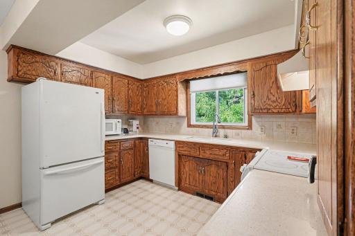 Hard surface counters and tile backsplash are neutral and classic.