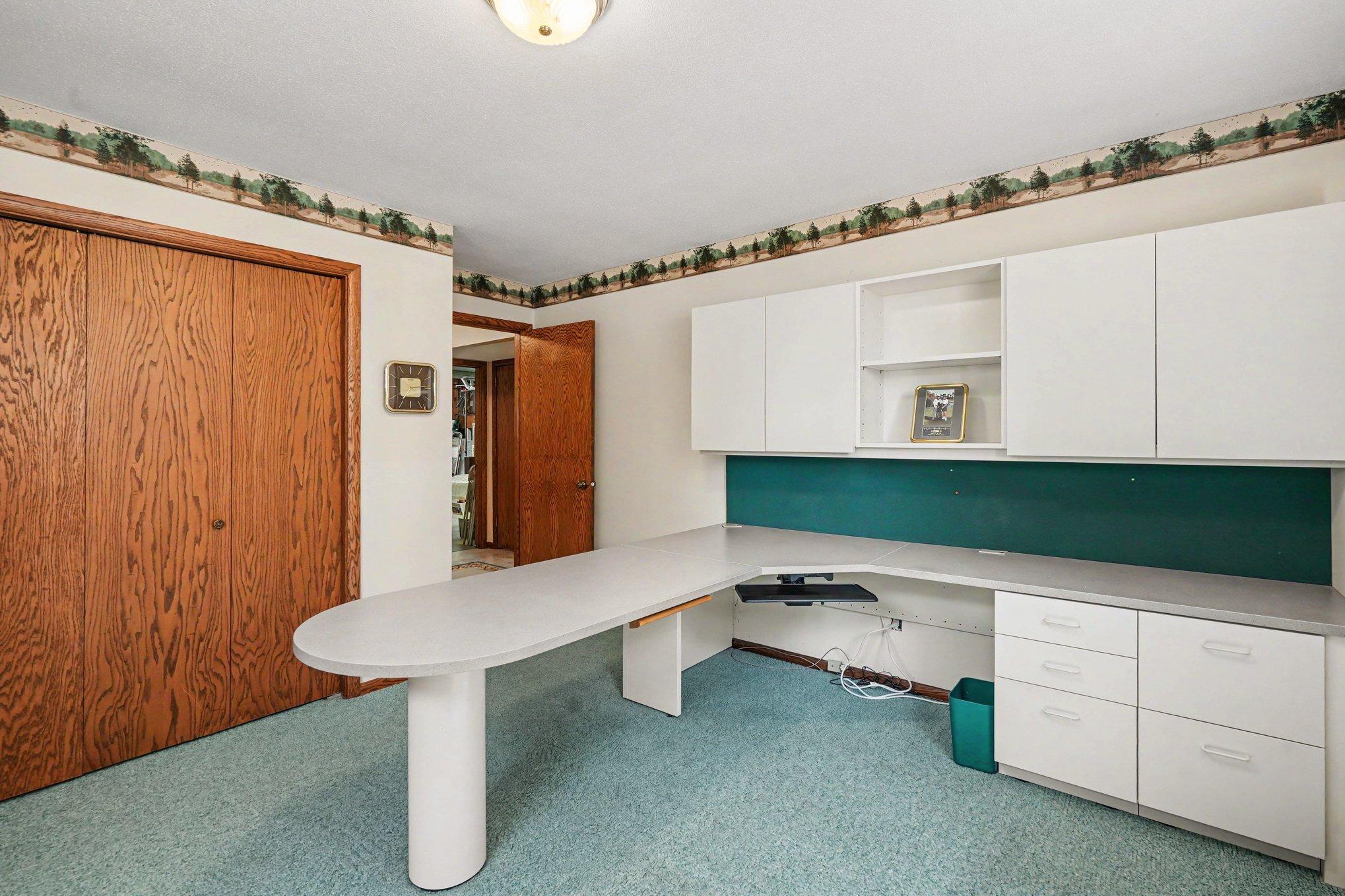 Fourth bedroom currently set up as workspace. Keep this built-in desk or convert it back to a bedroom.