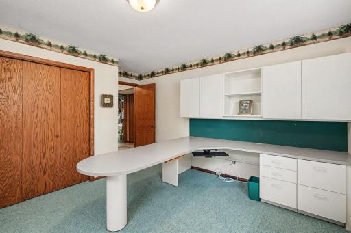Fourth bedroom currently set up as workspace. Keep this built-in desk or convert it back to a bedroom.
