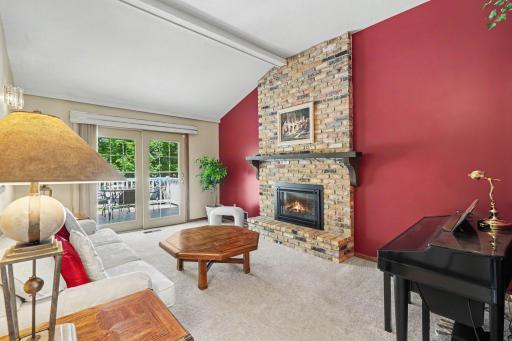 Main floor family room with access to deck. Ceiling is vaulted and there are oak pegged wood floors under carpet!