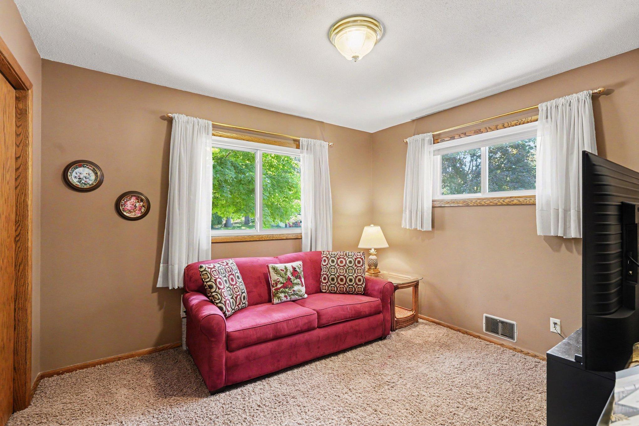 Second upper-level bedroom currently set up as a TV room. Twin beds or queen bed fit easily into this room. Hardwood floors under the carpet.