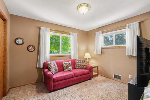 Second upper-level bedroom currently set up as a TV room. Twin beds or queen bed fit easily into this room. Hardwood floors under the carpet.