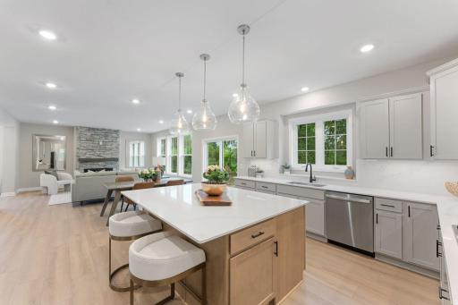 (Photo of a similar home, actual finishes may vary) The kitchen features a center island, quartz countertops, a GEÂ® Slate appliance package and soft-close cabinetry