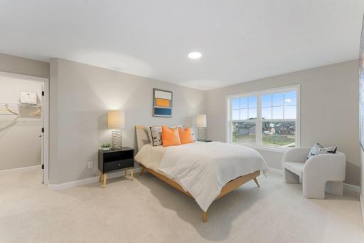 (Photo of a similar home, actual finishes may vary) This bedroom located on the second floor features an en-suite bathroom and a walk-in closet.