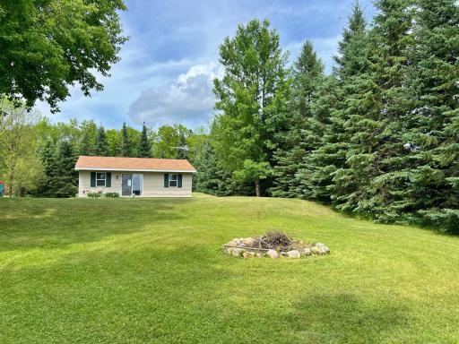 View of Home and Fire Pit in the yard.jpg
