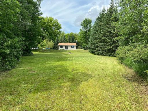 Lake view of grassy level yard and home.jpg