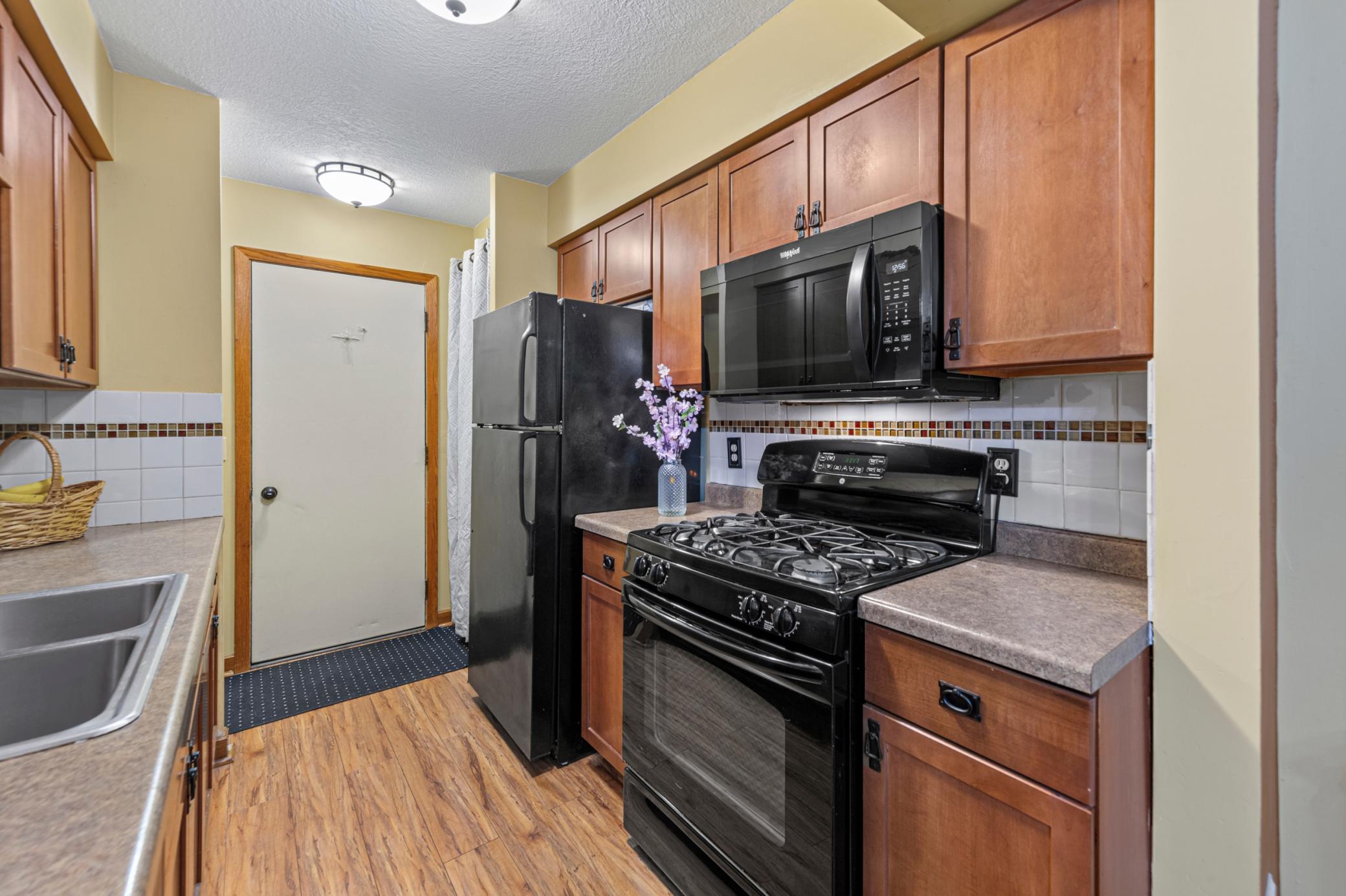 Kitchen towards garage. Nice pantry area behind curtain
