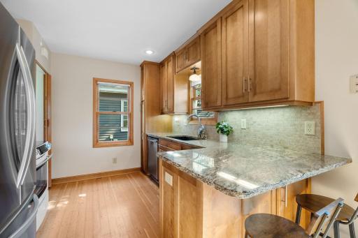 Granite countertops, tile backsplash, solid wood cabinets, under-cabinet lighting
