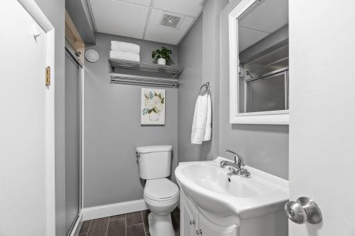 Basement 3/4 bath with ventilation fan and daylight window.
