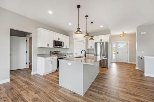 Custom kitchen with granite tops and stainless steel appliance package - *Photo of previous spec - colors may vary on current spec home*