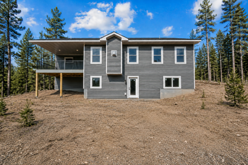 Sitting on over 5 acres of land and nestled within pines! - *Photo of home and lot are very similar but not exact location*