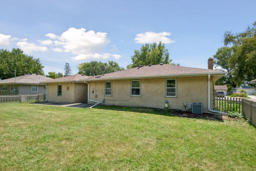 Back of stucco home and yard